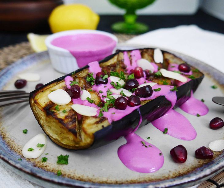 Baked aubergine with beetroot tahini dressing and pomegranate